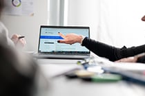 Teacher pointing at a laptop