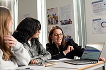 Teacher working with two students