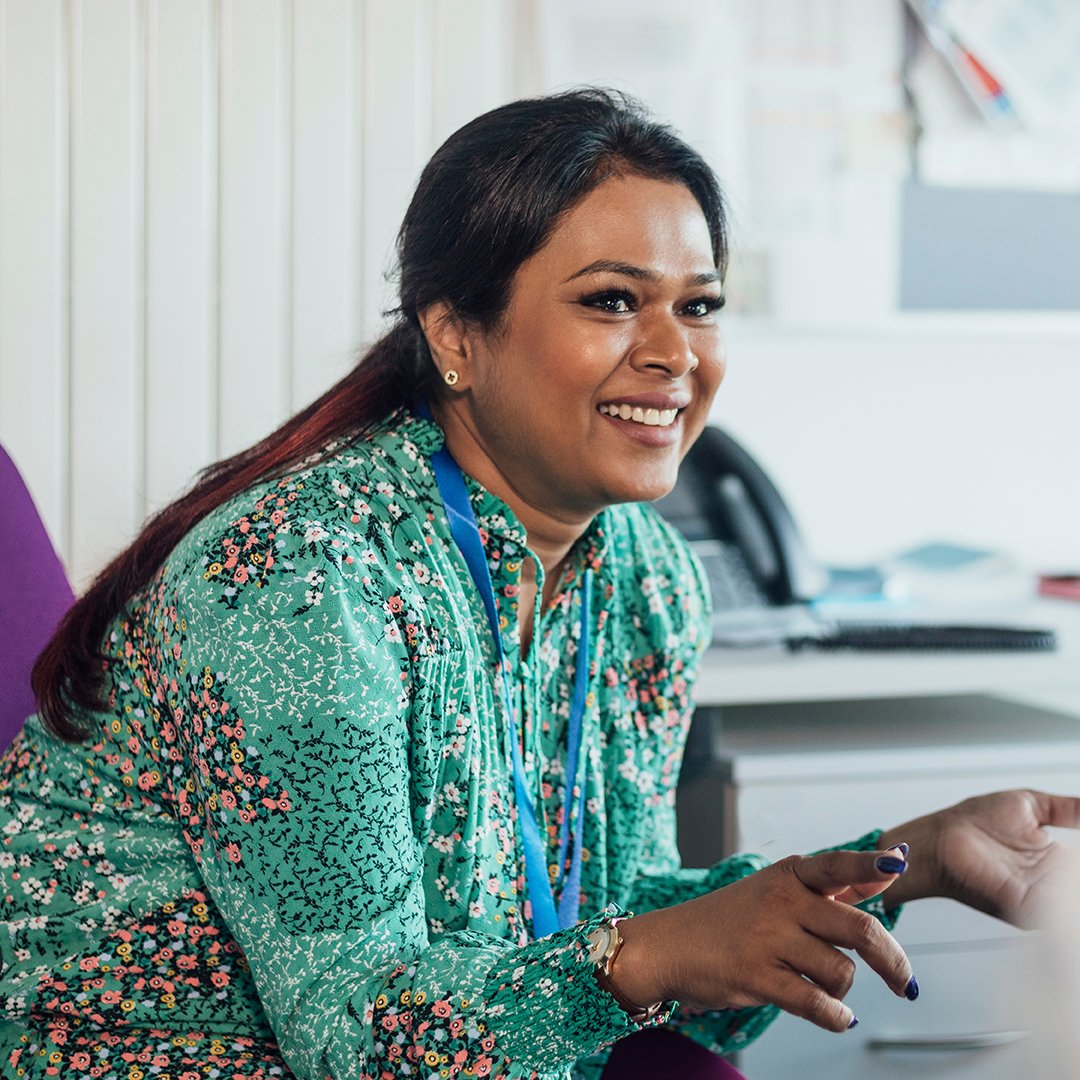 A teacher smiling and working A teacher smiling and working