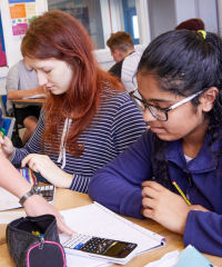 Female maths students working at desk