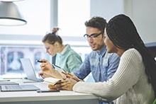 Teachers at a computer