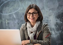 Teach Cambridge - Lady smiling in front of laptop