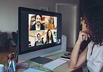 Lady talking to 4 others on computer