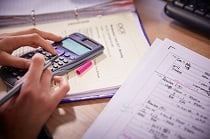 Person using a calculator at a desk