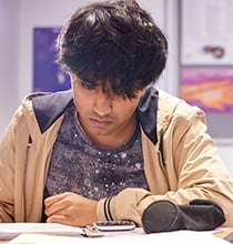 Male student sitting at desk 