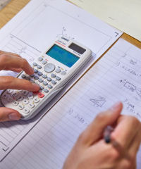 Student working with a calculator