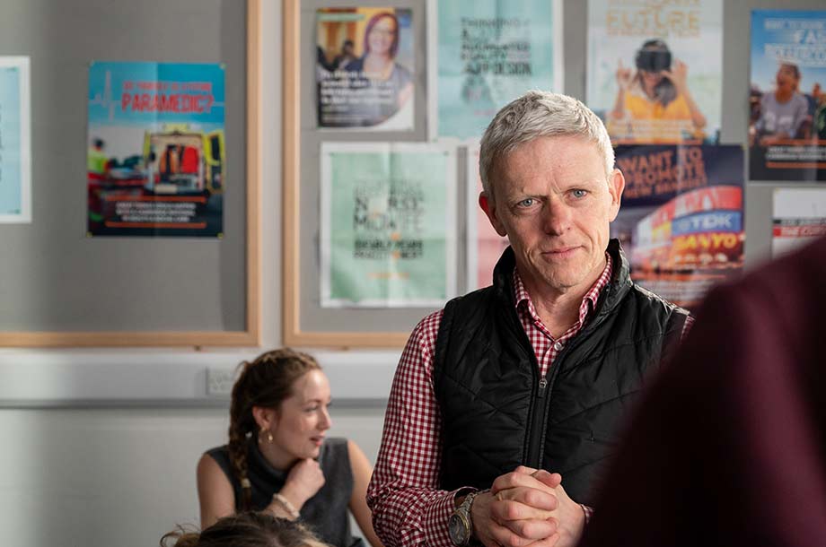 Teacher talking in room to individual