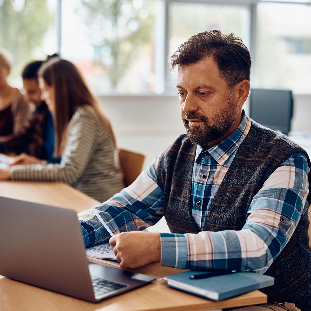 A teacher working on a laptop A teacher working on a laptop